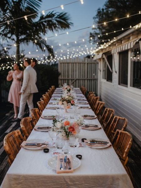 a long table with a couple standing behind it